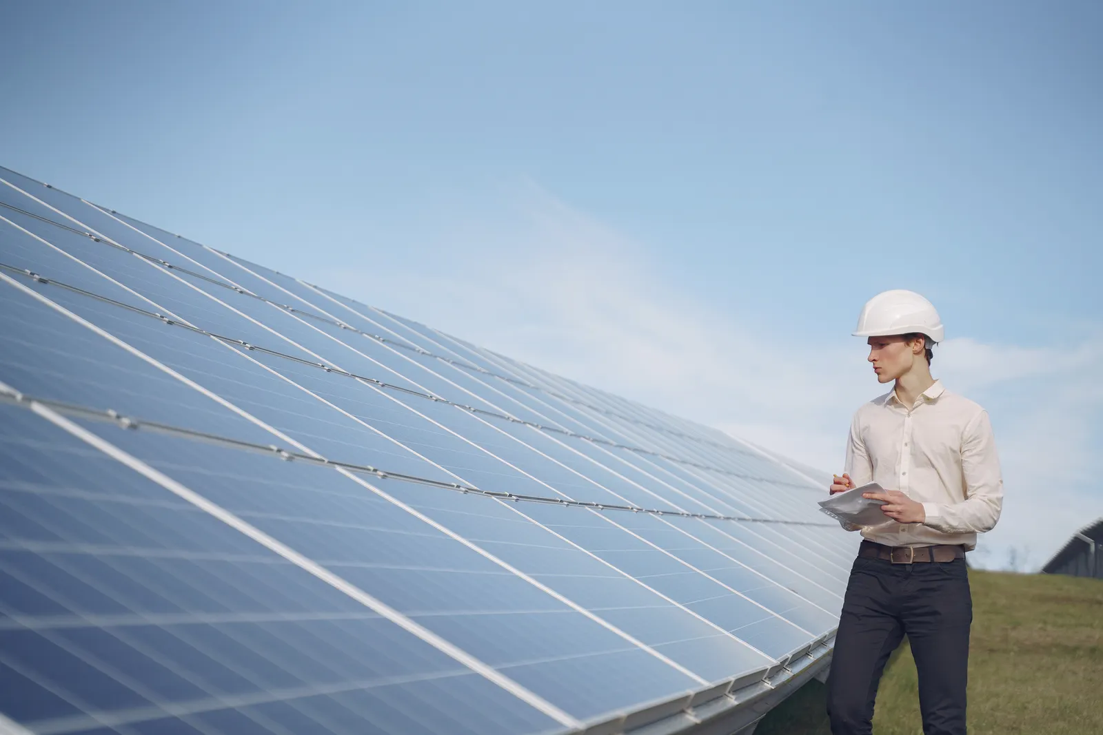 Solar technician inspecting a rooftop solar array