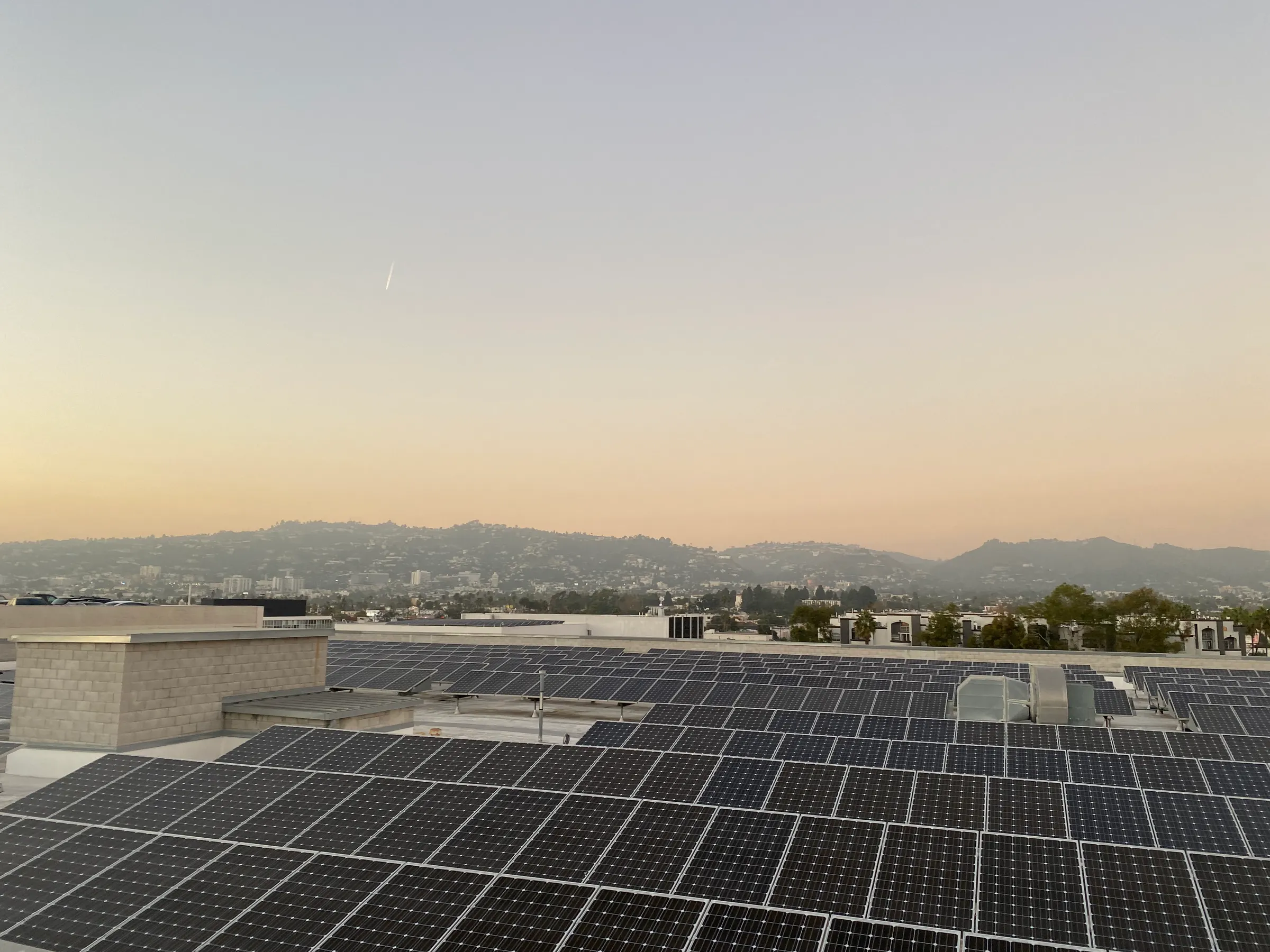 Rooftop solar panels at sunset